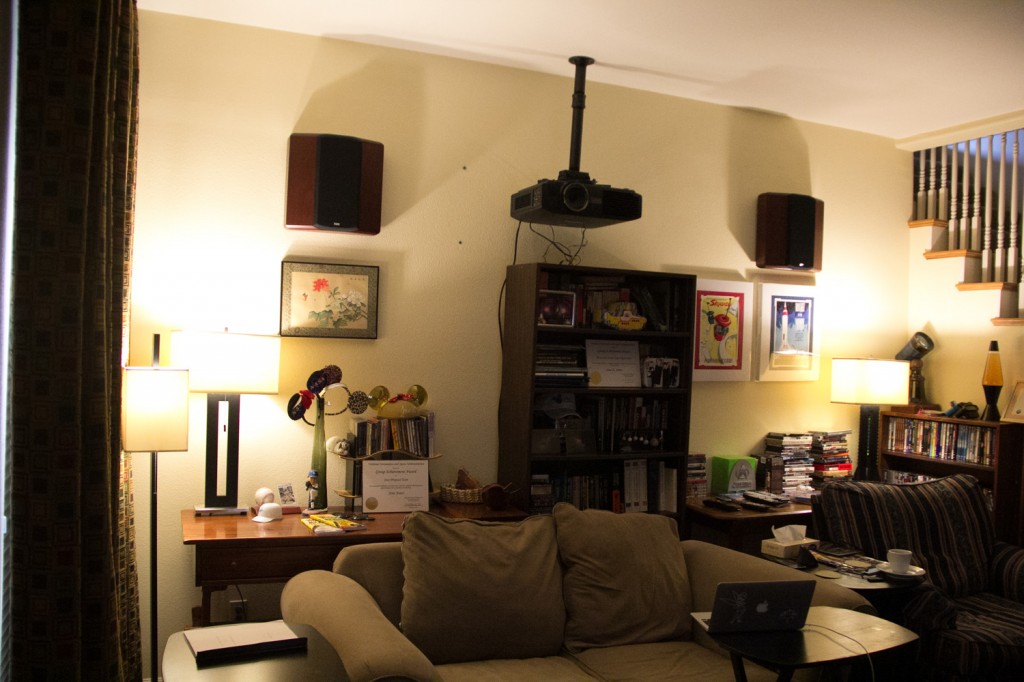 The Philips Hue bulbs in a more natural low color temperature lighting, also showing the projector ceiling mount and surround speakers.